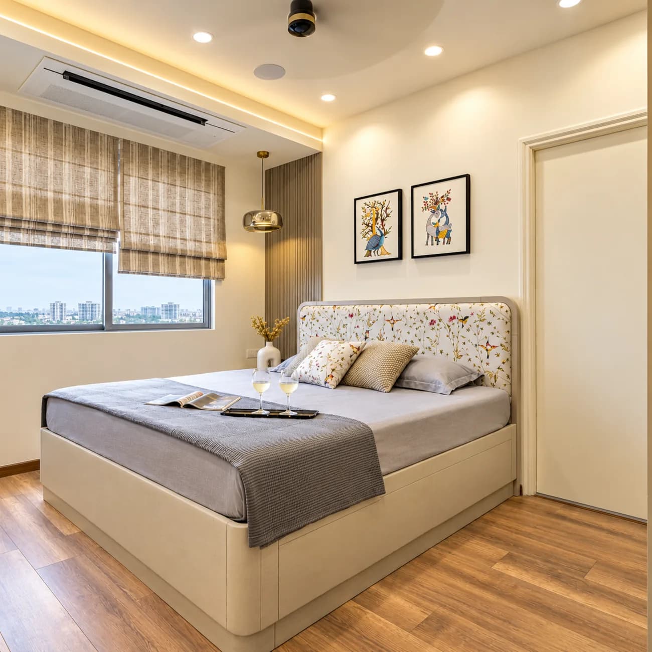 A bedroom with bedside reading lights, planting and a soft overhead wash
