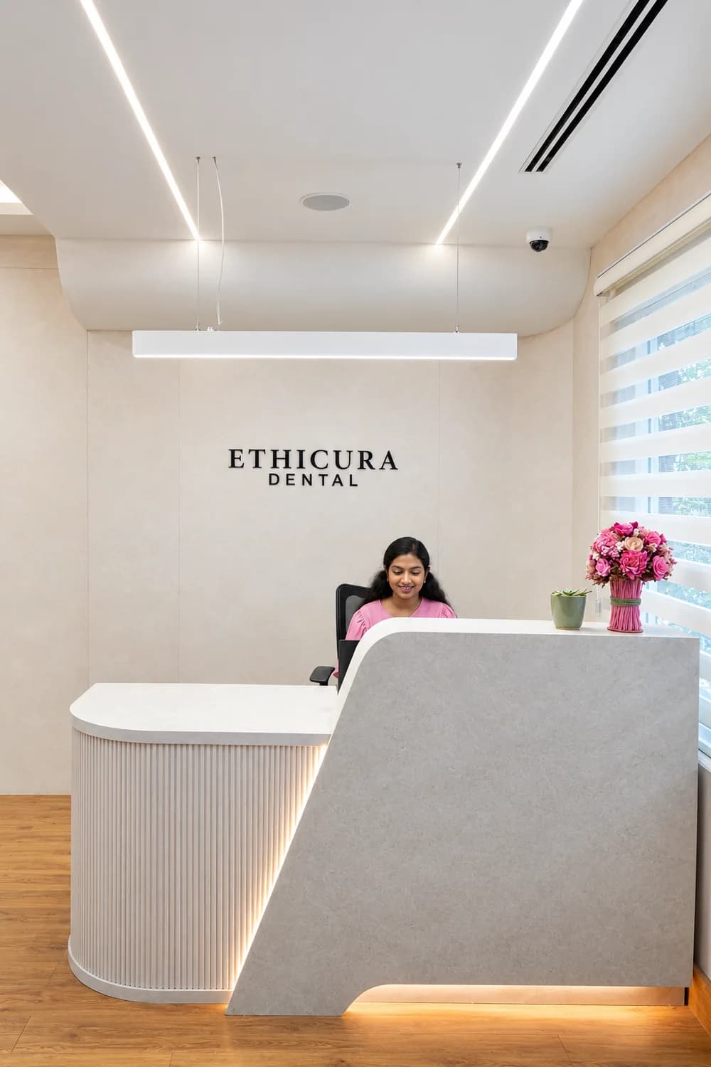 A detail of the Ethicura Dental reception desk and its lighting